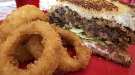 Steak sandwich and onion rings
