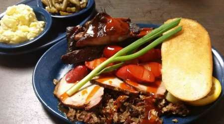 Mixed BBQ meat platter with sides