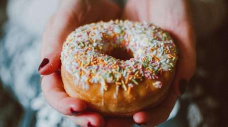 Vanilla glazed donut with sprinkles