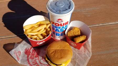 Cheese burger, chicken nuggets, fries and a drink