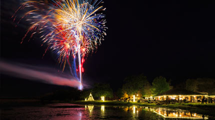 Firework show over lake at Cow Thieves & Outlaws at Woolaroc