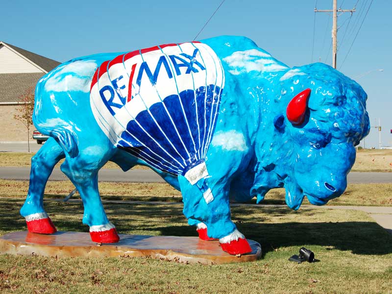 Up and Away Sky blue painted buffalo sculpture with Remax hot-air balloon and logo