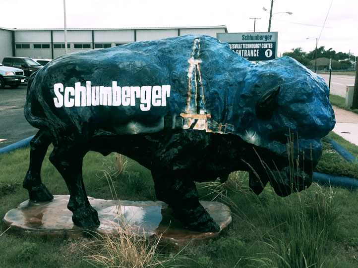 Schlumberger Buffalo Dark green painted buffalo sculpture with Schlumberger logo and drill rig