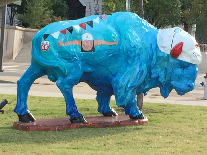 Splash Buffalo sculpture painted blue with swimming cap.